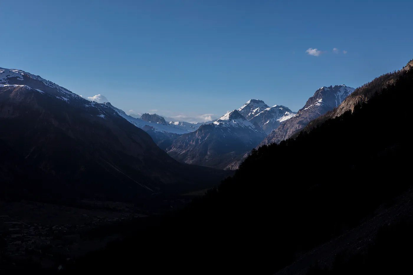 The Clarée valley in the French Alps at first light, snow still on the high peaks.